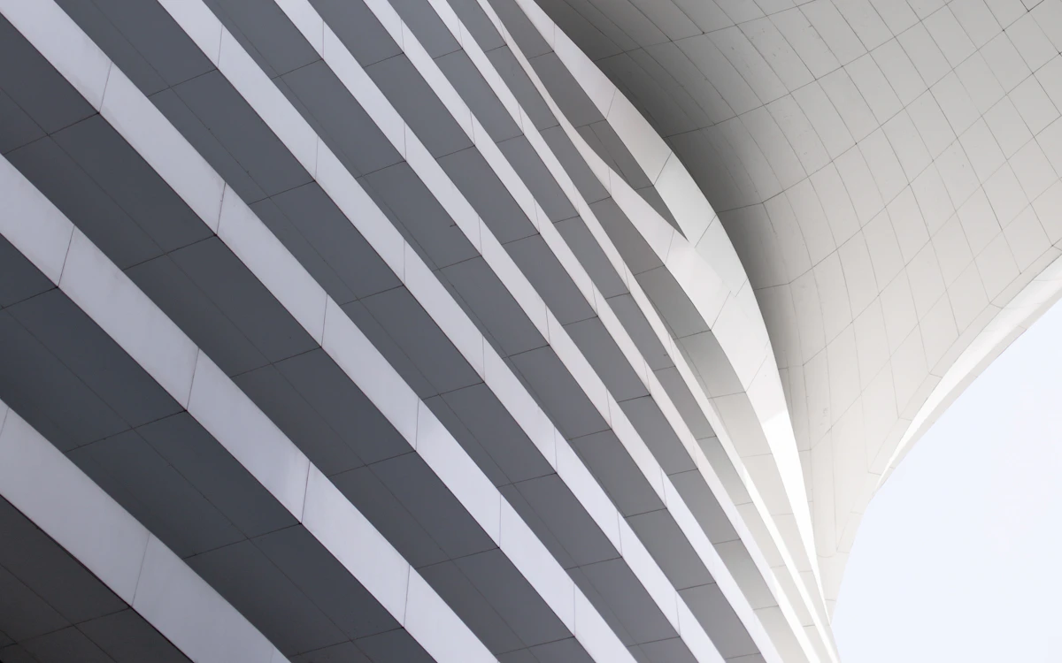 a curved building with a sky background