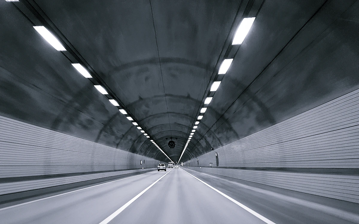 time lapse photography of vehicle under tunnel