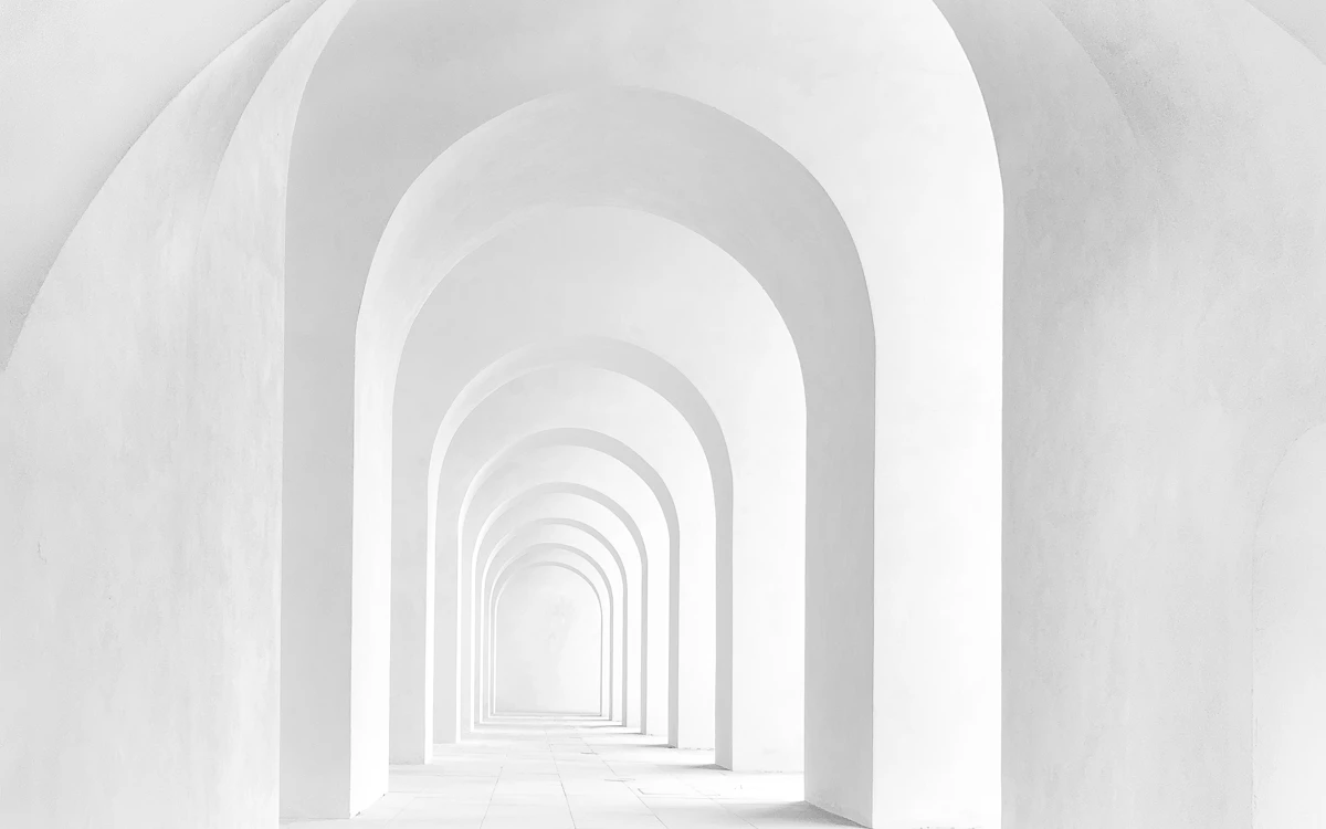 white archway corridor with stairs