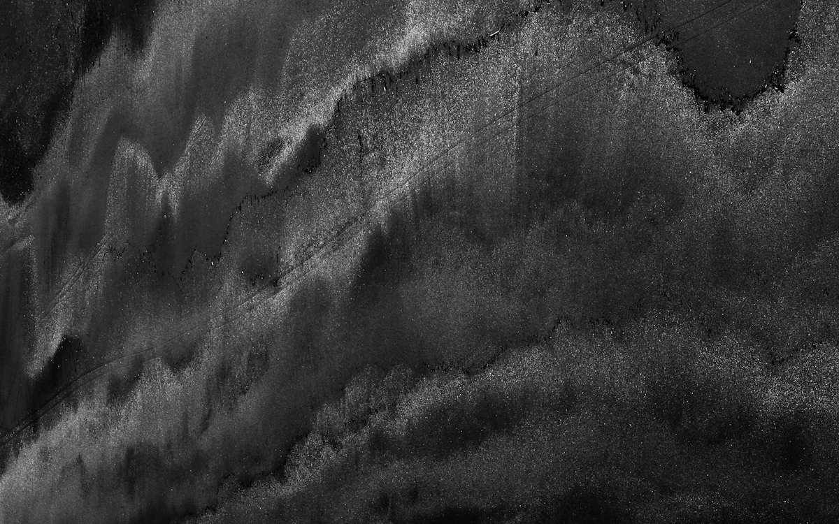 aerial black sand beach with wave