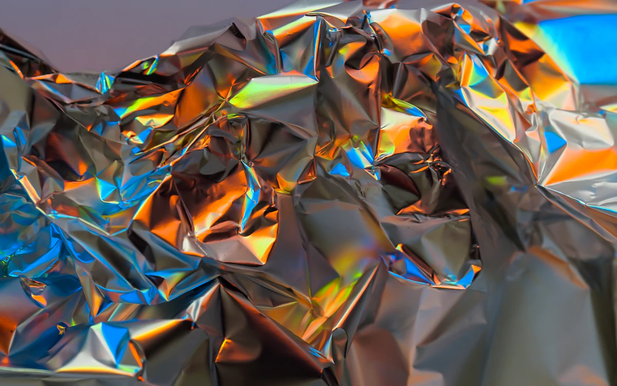 a close up of a shiny surface with a blue sky in the background