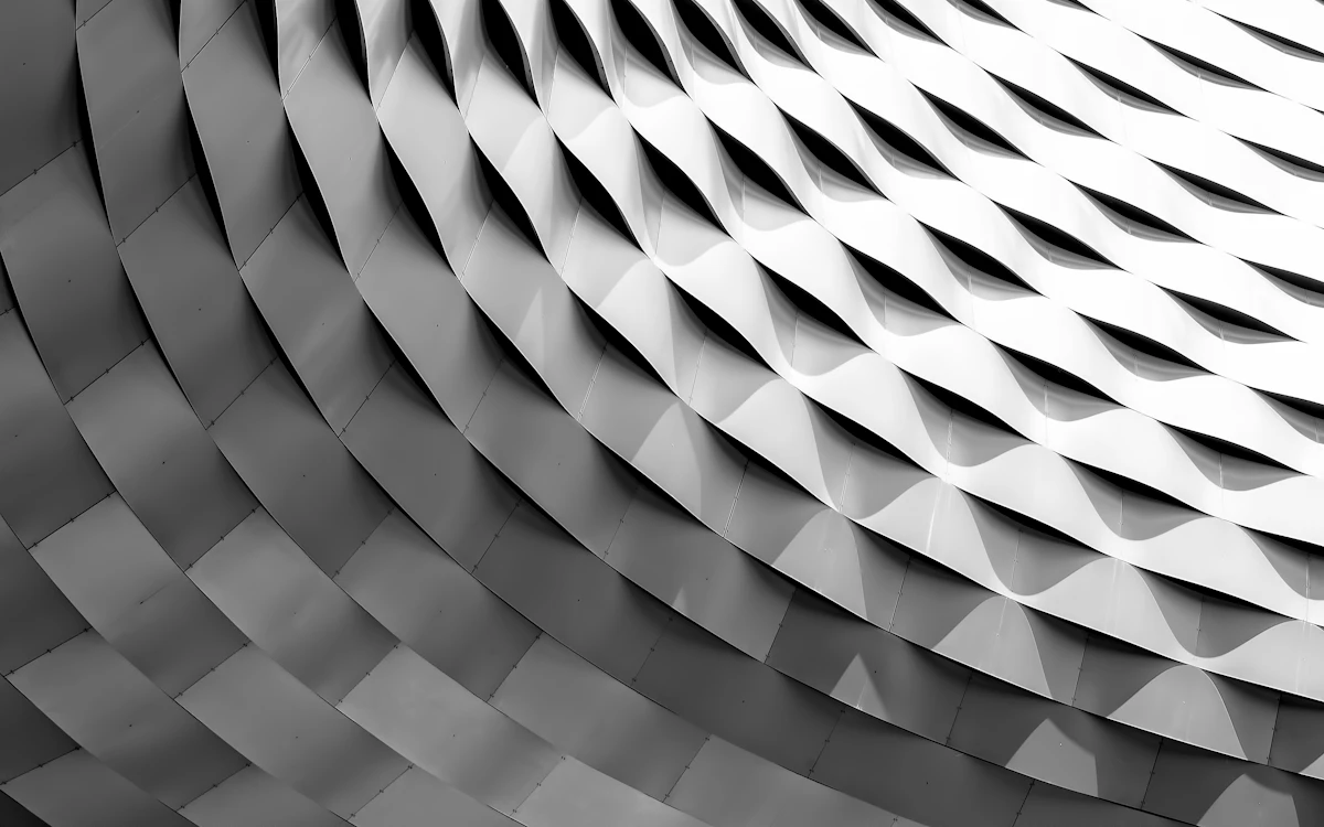 A curved facade covered in white latticework