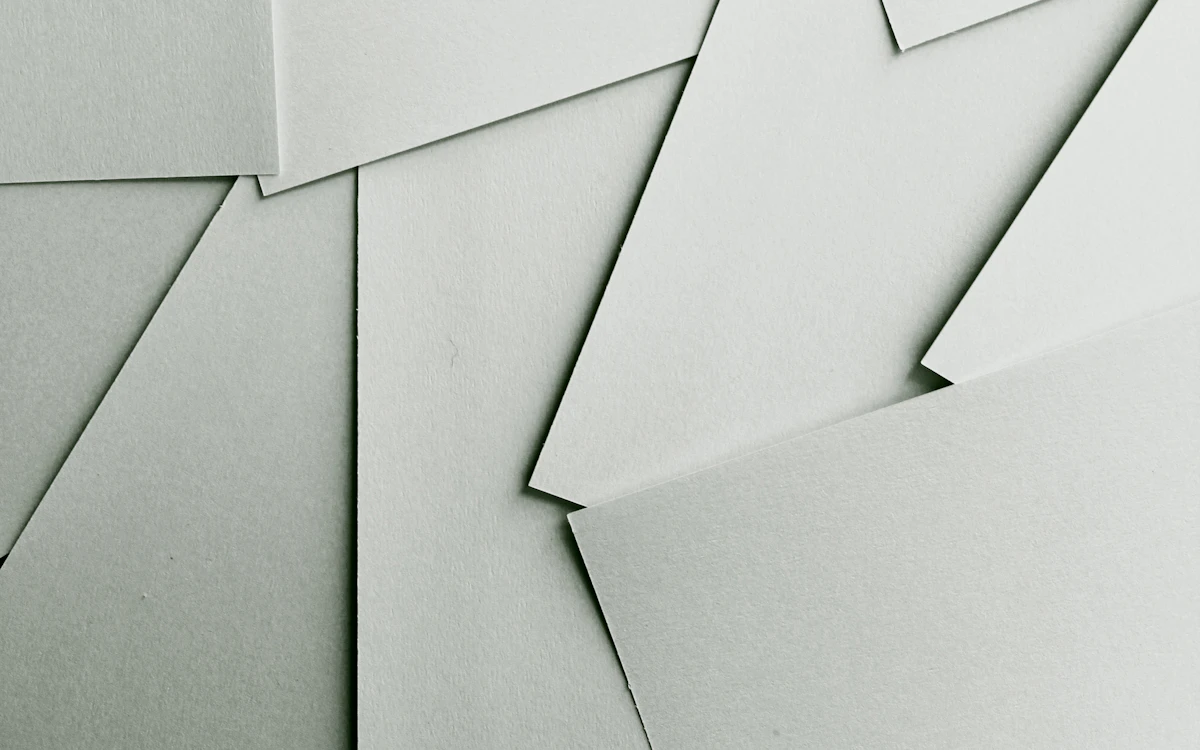 Scattered sheets of white paper covering the entire frame