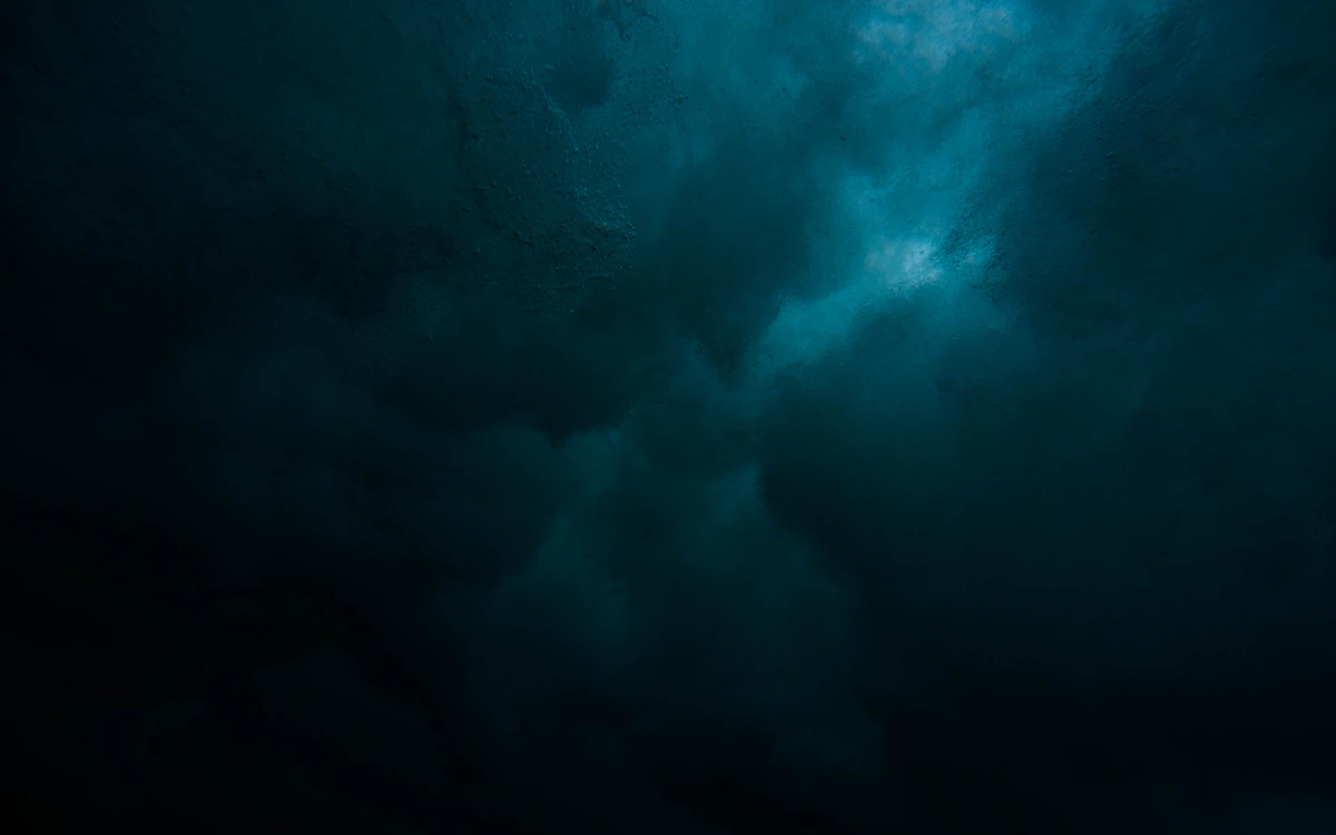 a large body of water under a cloudy sky