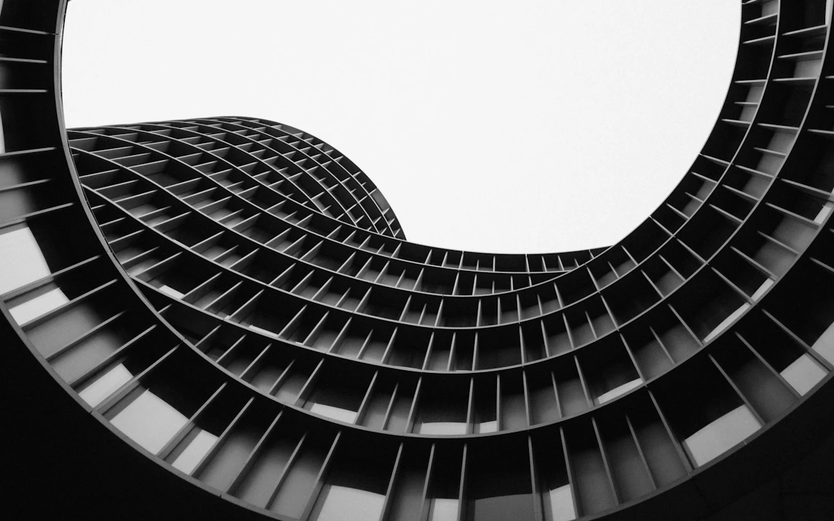 The curved facade of Axel Towers in Copenhagen against a bright sky