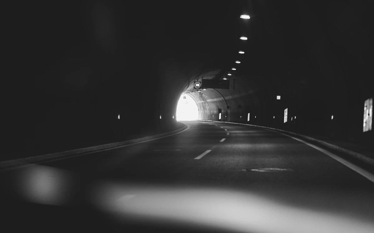 grayscale photography of a tunnel
