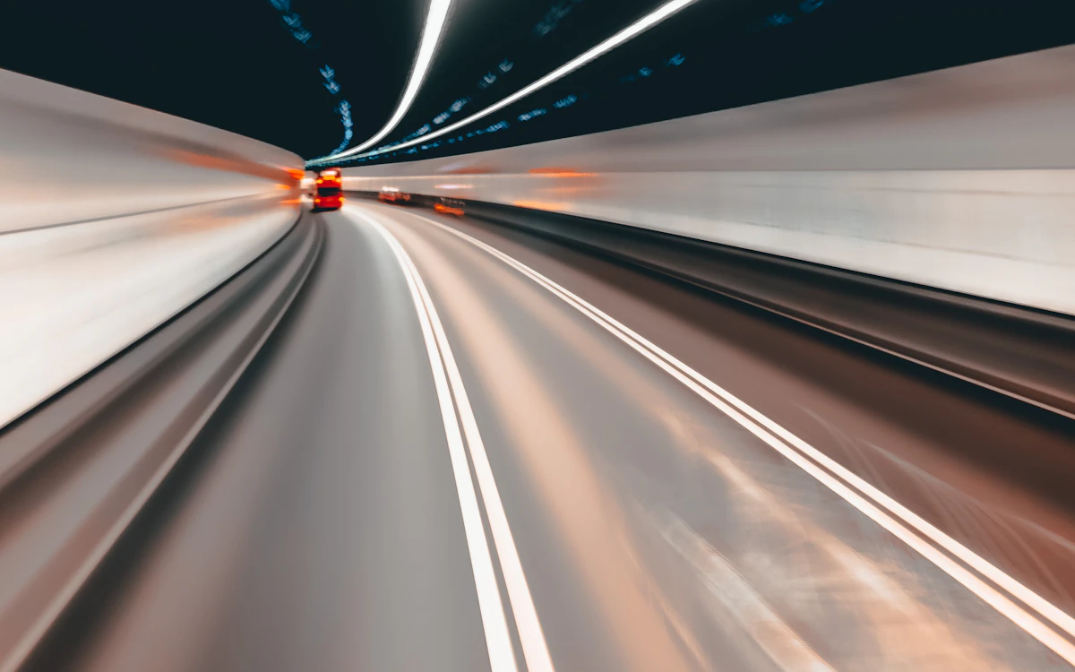 a blurry photo of a car going through a tunnel